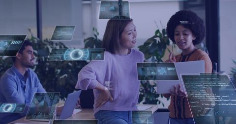 Business Professionals Analyzing Digital Data Overlaid on Screens