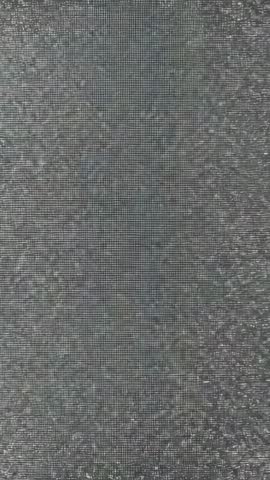 Vertical static noise loop displaying grayscale pixels and subtle glitch texture