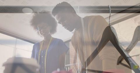 Innovative Clothing Designers Collaborating in Creative Studio