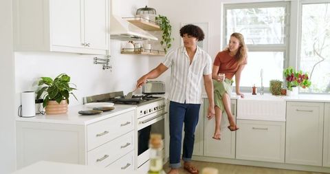Diverse Couple Cooking Together in Sleek Modern Kitchen