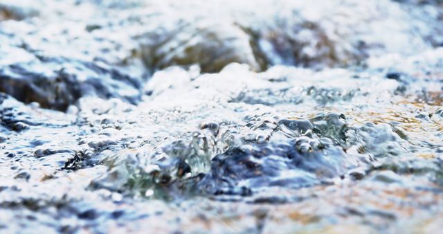 Vibrant close-up image captures flowing water with detailed ripples, conveying a sense of motion and tranquility. The texture and clarity of the water make it suitable for environmental themes, relaxation visuals, natural backgrounds, and water conservation promotions.