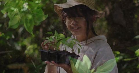 Girl with Seedling Tray in Forest Environment