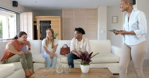 Diverse friends engaging in group discussion over tablet