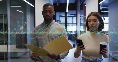 Coworkers walking through modern office holding folder and phone with waveform overlay