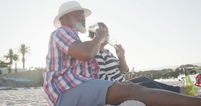 Senior Couple Relaxing on Beach Drinking Wine, Enjoying Sunset - Download Free Stock Images Pikwizard.com