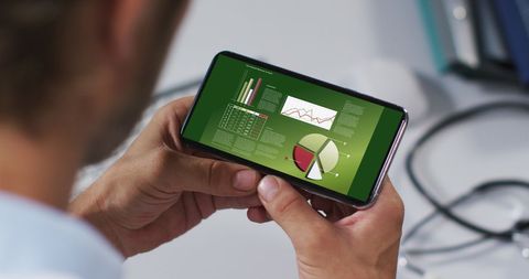 Analyzing Business Data on Smartphone Screen in Office - Download Free Stock Images Pikwizard.com