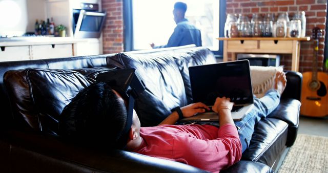 Person Lying on Sofa Using Laptop in Living Room - Download Free Stock Images Pikwizard.com