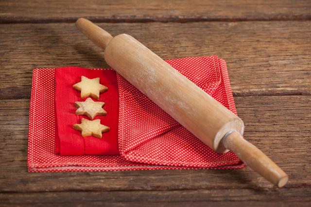 Close-up of cookies and rolling pin on napkin during christmas time