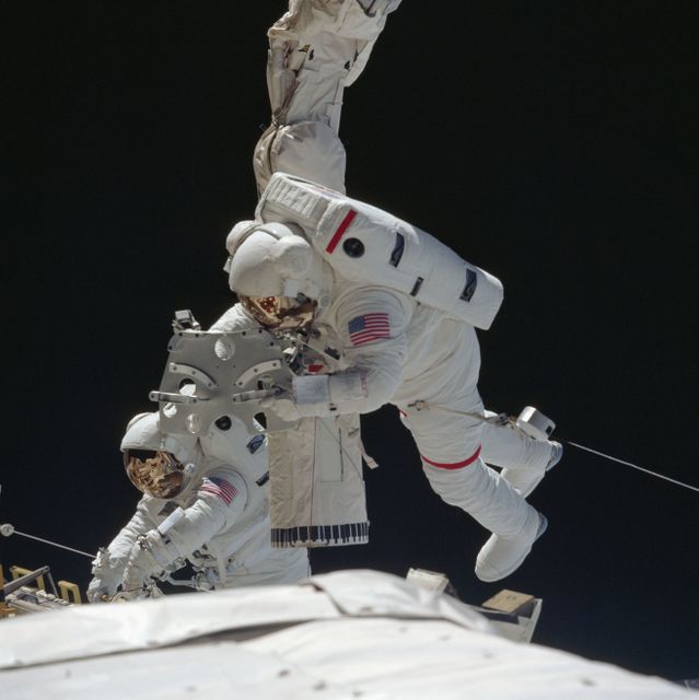 Astronauts engaged in a spacewalk perform maintenance outside the Space Shuttle Endeavour on June 25, 1993. One astronaut adjusts the mobile foot restraint on the end of the Remote Manipulator System while another interacts with the European Retrievable Carrier (EURECA). This dynamic image is perfect for illustrating topics related to space missions, NASA activities, technological advancements in aerospace, or aspiring astronaut programs.