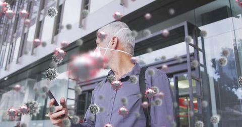 Senior man wearing face mask with covid-19 virus concept overlay