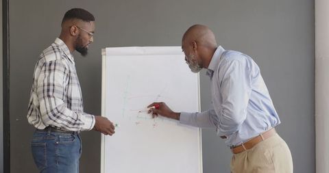 Business Professionals Discussing Data Trends in Corporate Office