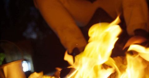 Warm crackling fire pit flames lighting night