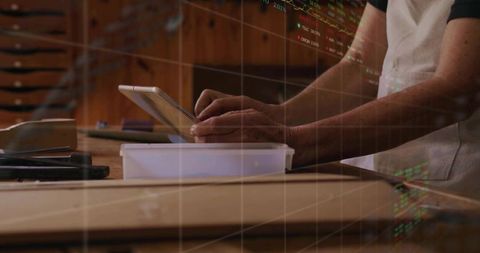 Craftsperson Using Tablet in Woodworking Studio