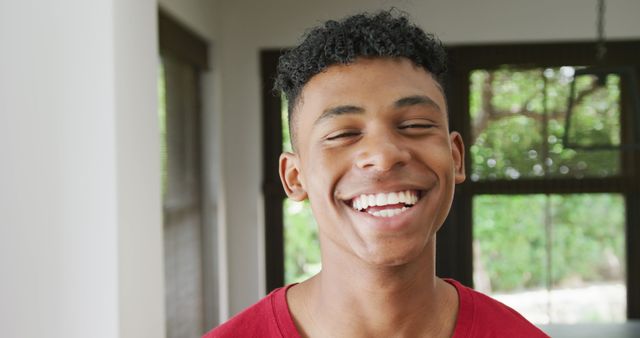 Young Man Smiling with Joy Inside Bright Room - Download Free Stock Images Pikwizard.com