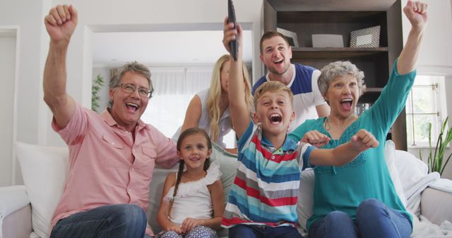 Excited Multigenerational Family Celebrating Together in Living Room - Download Free Stock Images Pikwizard.com