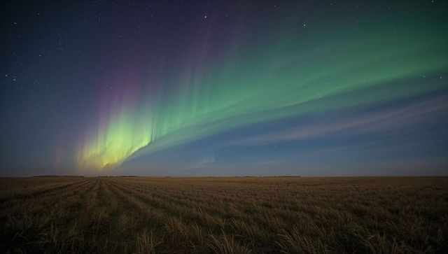Aurora Borealis Dancing Over Prairie Nightscape With Green and Purple Curtains and Stars