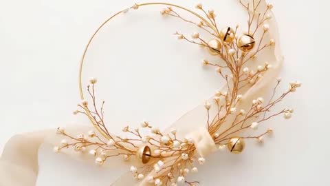 Golden hoop wreath swaying with sheer ribbon and jingle bells for elegant holiday loop