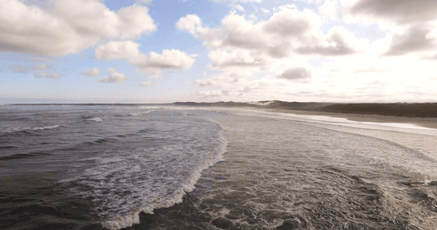 scenic clouds over transparent ocean waves and sandy beach - Download Free Stock Videos Pikwizard.com