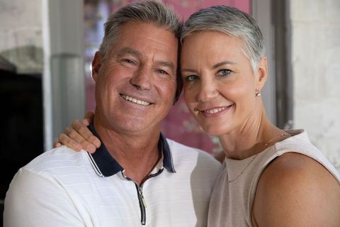 Happy Senior Couple Embracing with Warm Smiles