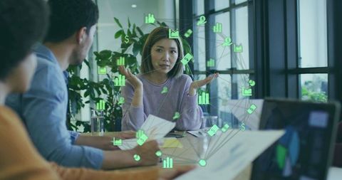 Team Meeting with Financial Icons Overlay in Modern Office