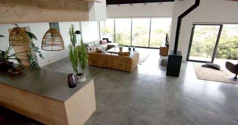 Modern living room with large windows and cozy decor