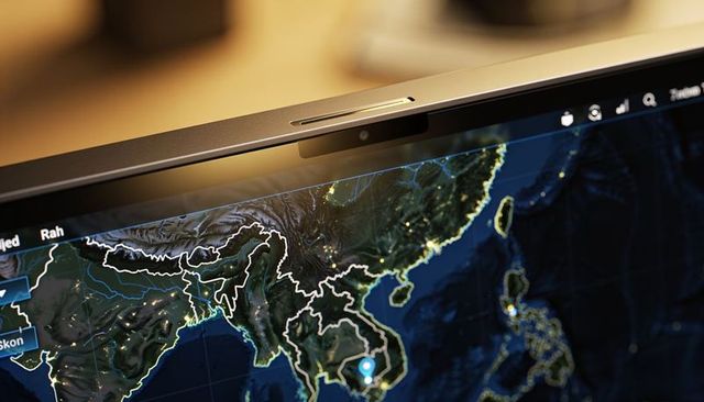 Laptop webcam above nighttime south and southeast asia digital map with blue location pin
