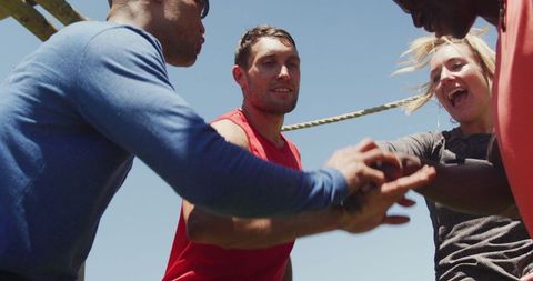 Diverse Group Celebrating Team Success in Outdoor Boot Camp
