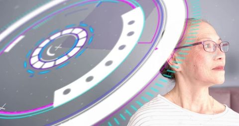 Senior asian woman gazing at holographic augmented reality interface in modern lounge