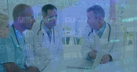 Doctors Analyzing Healthcare Data on Laptop