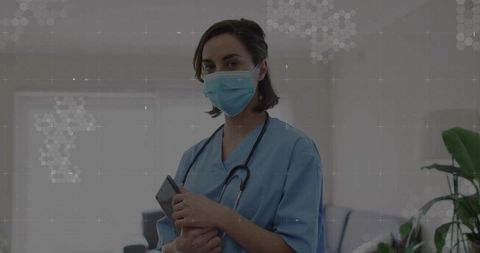 Confident Female Health Worker Holding Smartphone in Clinical Setting