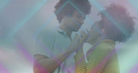Dreamy pastel couple leaning and holding hands, intimate gaze and prism light overlay
