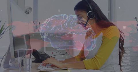 Woman Wearing Yellow Typing with Overlay of Brain Visualization
