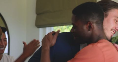 Joyful Wedding Reunion with Groom Embracing Friends