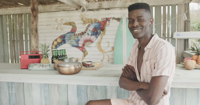 Smiling Man Relaxing at Outdoor Beach Bar - Download Free Stock Images Pikwizard.com