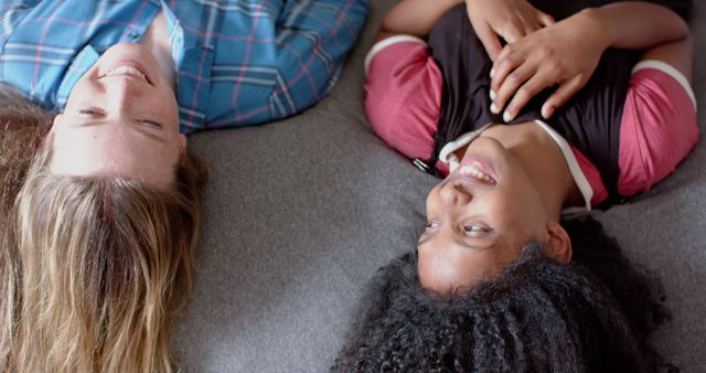 Diverse Friends Smiling While Lying on Gray Couch, Top-Down View - Download Free Stock Images Pikwizard.com