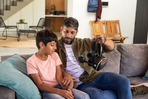 Father and Son Inspired by Virtual Reality on Cozy Sofa