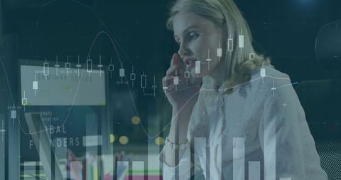 Businesswoman analyzing financial charts in modern office at night