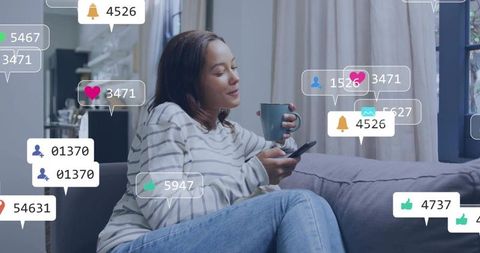 Relaxing woman scrolling phone and sipping coffee on sofa with social media notifications