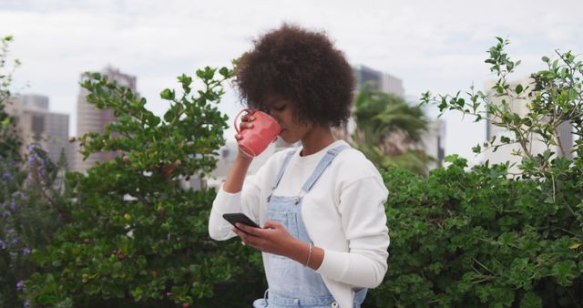 Young Woman Drinking Coffee while Using Smartphone in Urban Garden - Download Free Stock Images Pikwizard.com