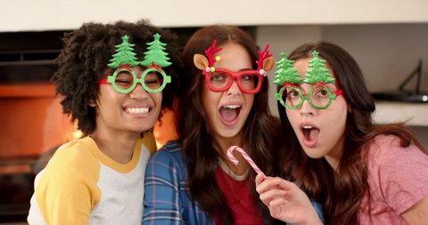 Cheerful Friends Celebrating Holiday Season with Novelty Glasses