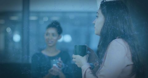 Designers discussing while enjoying coffee in creative studio