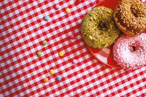 Colorful donuts on checkered tablecloth