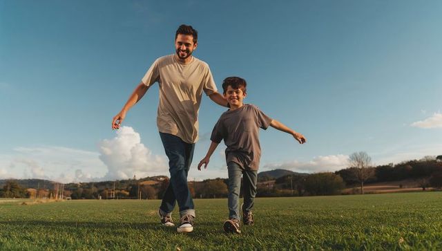 Father and Son Walking in Golden Hour Meadow Linking Arms and Smiling Outdoors