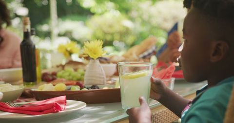 Joyful Family Garden Gathering with Child Drinking Lemonade - Download Free Stock Images Pikwizard.com