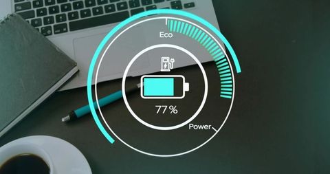 Circular battery hud showing 77% charge on modern workspace laptop notebook teal pen coffee cup