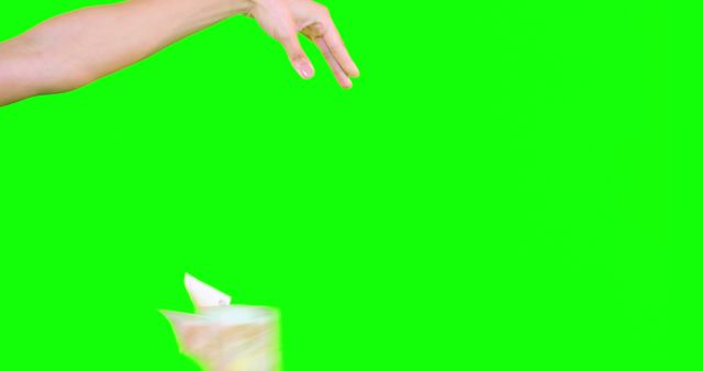 Hand Throwing Trash into Bin against Bright Green Background - Download Free Stock Images Pikwizard.com