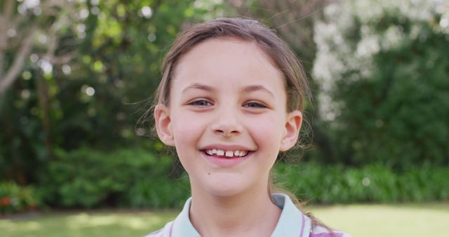 Smiling Young Girl Outdoors in Sunlit Garden - Download Free Stock Images Pikwizard.com