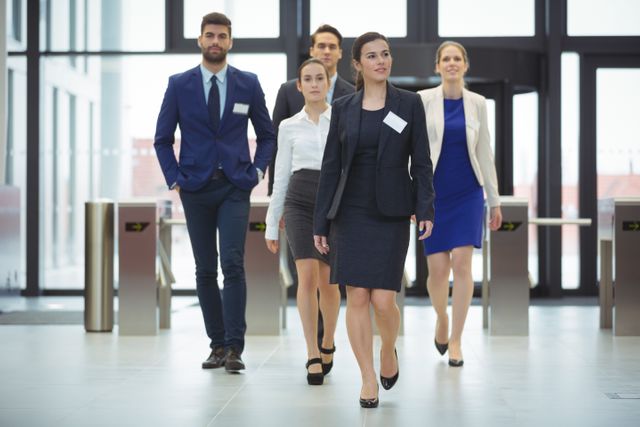 Businesspeople walking in a lobby at office