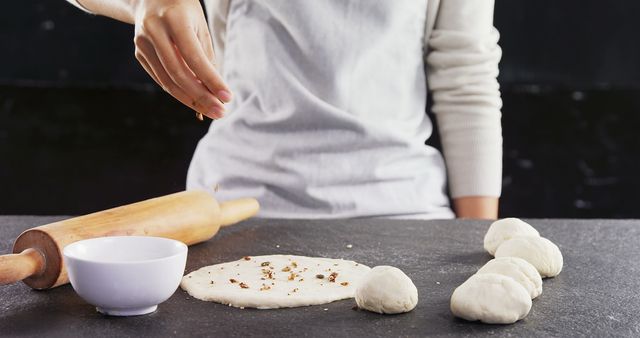 Baker Preparing Dough on Black Surface with Rolling Pin - Download Free Stock Images Pikwizard.com