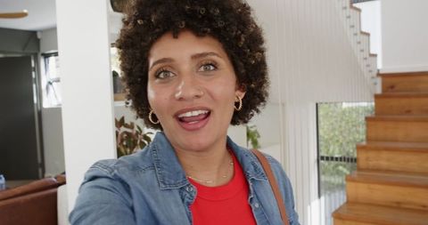 Young Woman Vlogging at Home Near Wooden Staircase
